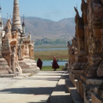 monks running thru pagoda